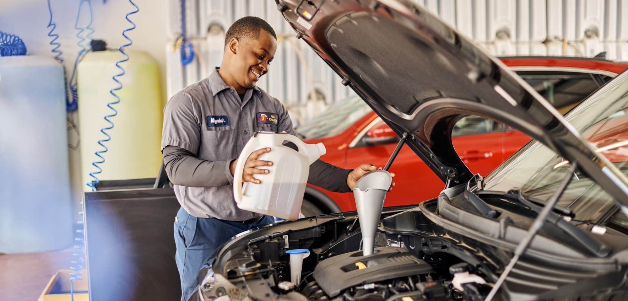 Take 5 Technician Refilling Oil