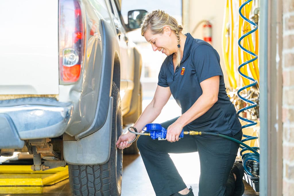 Take 5 technician checking tire pressure.